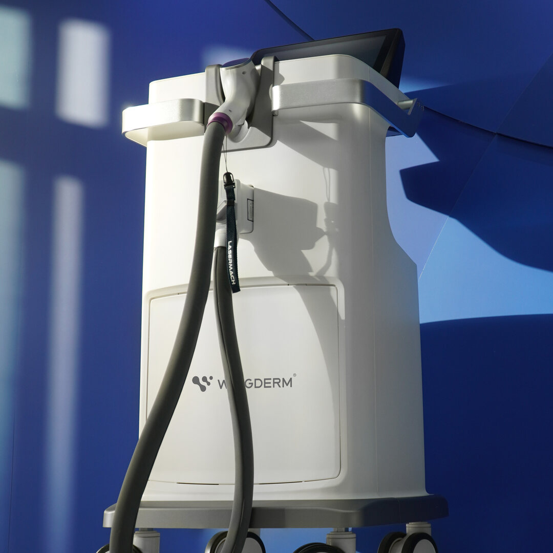 The WingDerm LaserMach unit with the handpiece in its cradle